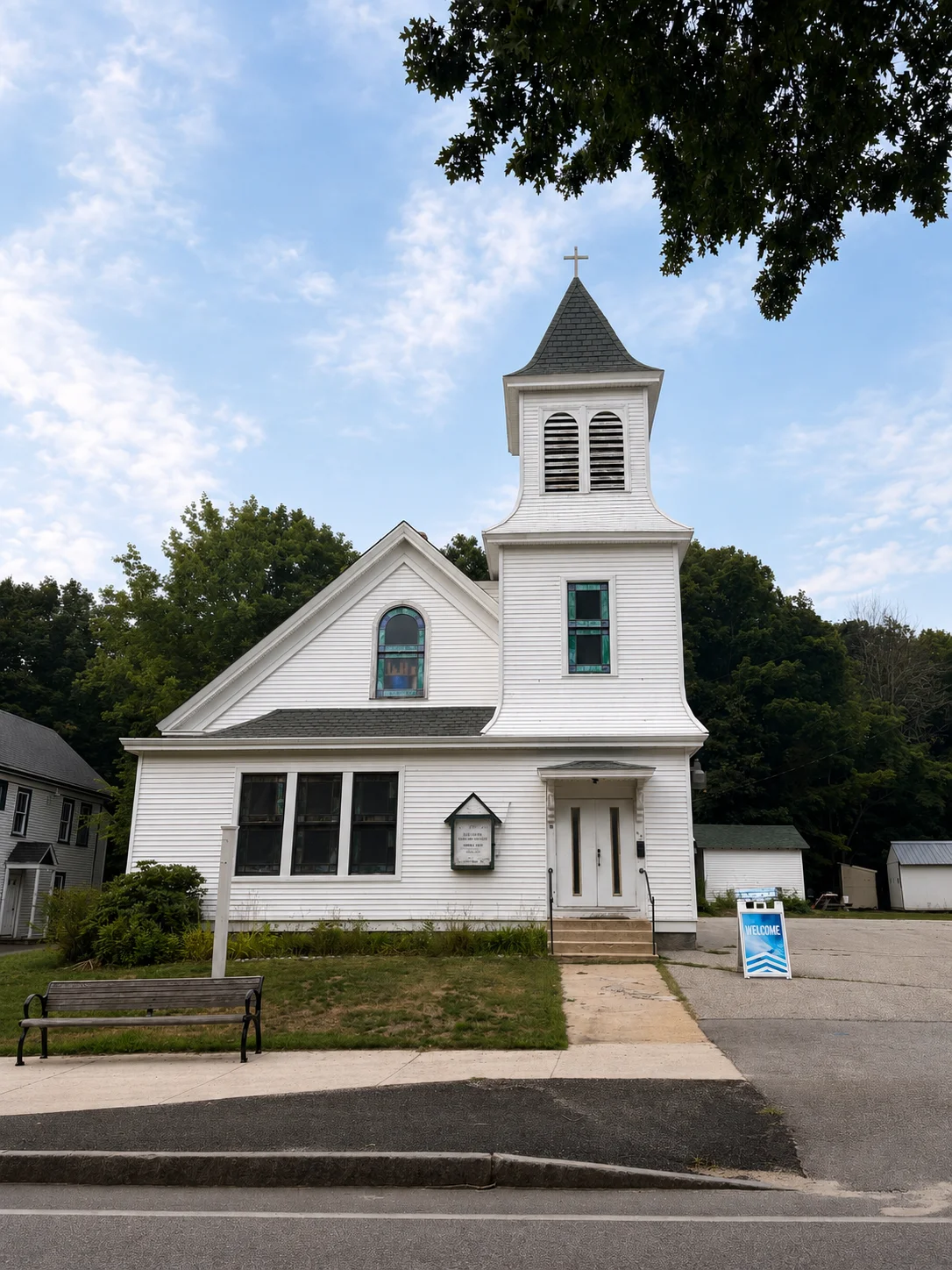 Lake Region Vineyard church building with a steeple and welcome sign